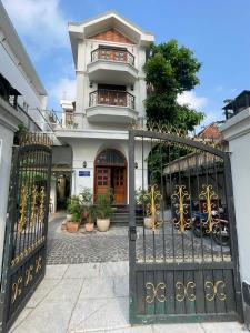 a gate to a house with a building at Mận Đào Villa in Ho Chi Minh City