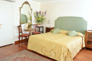 En eller flere senge i et værelse på Hotel San Zulian