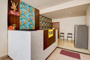 an office lobby with a reception counter and a refrigerator at FabHotel Relax Inn Executive in Pune
