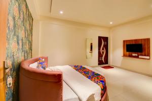 a hotel room with a bed and a tv at FabHotel Relax Inn Executive in Pune