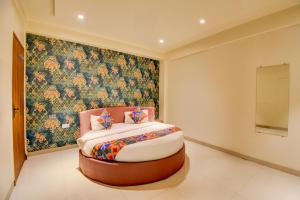 a bed in a room with a painting on the wall at FabHotel Relax Inn Executive in Pune +17 photos