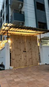 a wooden gate in front of a building at Dia Inn in Bori