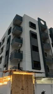 a tall white building with windows and a clock on it at Dia Inn in Bori