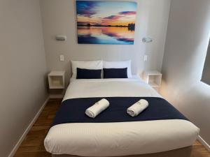 a bedroom with a bed with two pillows on it at Clarence Head Caravan Park in Iluka