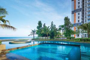 a swimming pool with a view of the ocean at Timurbay Residences in Kuantan
