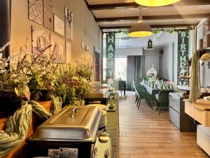 a restaurant with a waiting room with plants in it at Pension Restaurant Luna in Treis-Karden