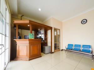 a waiting room with blue chairs in a building at RedDoorz @ Pandu Raya Bogor in Bogor