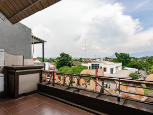 a balcony with a view of a city at RedDoorz @ Pandu Raya Bogor in Bogor