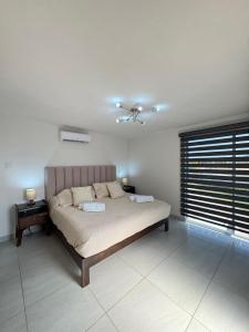 a bedroom with a bed and a window at BellitasHouse Dream Acapulco Lujo y Confort in Acapulco +27 photos