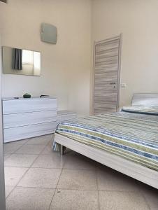 a bedroom with a bed and a dresser at Cefalù Station House in Cefalù