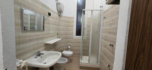 a bathroom with a sink and a toilet and a shower at The SISTERS in Castel Maggiore +10 photos