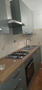 a kitchen with a sink and a stove top oven at The SISTERS in Castel Maggiore