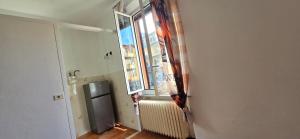 a room with a window and a radiator in it at The SISTERS in Castel Maggiore