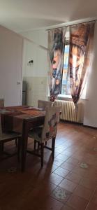 a dining room with a table and a window at The SISTERS in Castel Maggiore