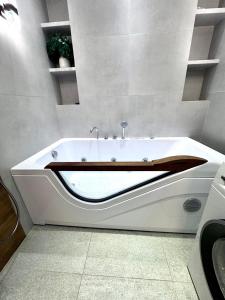 a bathroom with a bath tub in a room at Boulevard in Samarkand