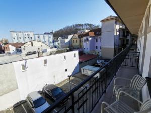 a balcony with a view of a city at Apartmán Stará Tržnica in Trenčín +6 photos