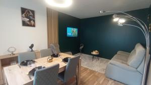 a dining room with a table and chairs and a lamp at Au 24 a connerre in Connerré