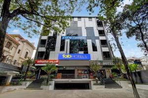 a building with a sign on the front of it at FabHotel Palm Tree in Hyderabad