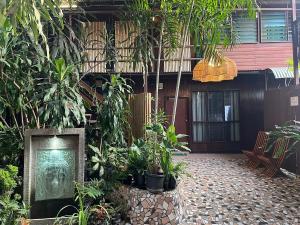 a courtyard with plants and a picture of a dog at Raintree Lodge in Port Moresby