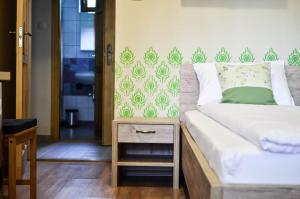 Postel nebo postele na pokoji v ubytování Páva Apartmanház
