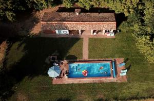 a person taking a picture of a swimming pool at PusztaFarm - Boutique Retreat with Wellness 6 to 8 Guests in Fülöpháza