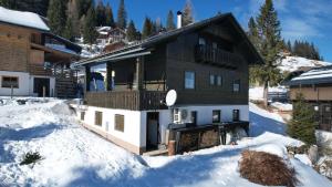 a house in the snow with snow around it at Knusperhäuschen Nassfeld in Sonnenalpe Nassfeld