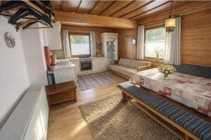 a room with a kitchen and a living room at Knusperhäuschen Nassfeld in Sonnenalpe Nassfeld