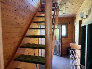 a staircase in a cabin with wooden walls at Knusperhäuschen Nassfeld in Sonnenalpe Nassfeld