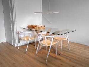 a dining room table with chairs and a glass top at Heggerank 5a in Nieuwvliet +7 photos