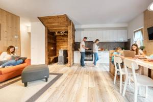 a family in the kitchen of a house at Incanto Walser Apartments Testa in Macugnaga +24 photos