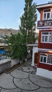a building with a sign on the side of it at Hotel Ech Aar, Kargil in Kargil