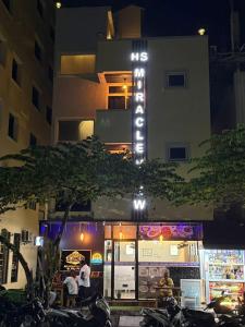 a building with a sign on the side of it at HS Miracle View in Hulhumale