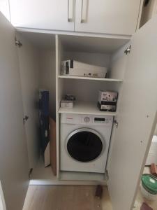 a laundry room with a washing machine in it at Kayani View in Taxiárkhai