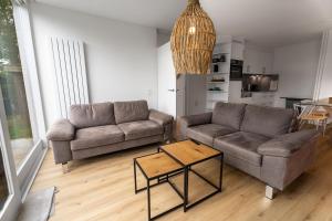 a living room with two couches and a table at Heggerank 5a in Nieuwvliet