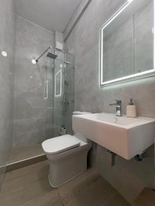 a bathroom with a sink and a toilet and a shower at Nikoletta's Studio 2 in Komotini