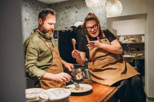 two men standing in a kitchen preparing food at Wolter Landhaus in Vipiteno +32 photos