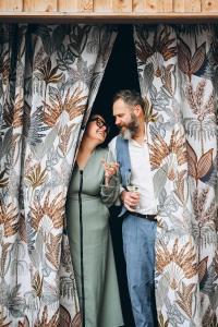 a man and a woman standing in a curtain at Wolter Landhaus in Vipiteno