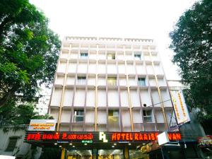 a tall white building with a sign in front of it at Hotel Raaj Bhaavan - US Consulate - Nungambakkam in Chennai