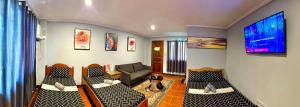 a living room with a couch and a flat screen tv at Chad's Lodge in Coron