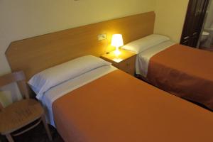 Postel nebo postele na pokoji v ubytování Hostal Prim