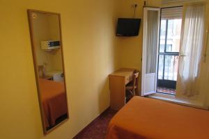 Postel nebo postele na pokoji v ubytování Hostal Prim