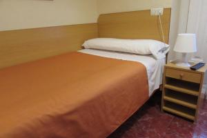 Postel nebo postele na pokoji v ubytování Hostal Prim