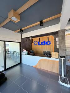a restaurant with a ll labs sign on the wall at Sleep Owl Surat Thani in Surat Thani