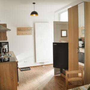 a kitchen with a tv in the middle of a room at Monte Baldo in Ilmmünster