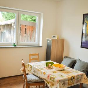 a kitchen with a table with a bowl of fruit on it at Monte Baldo in Ilmmünster +6 photos