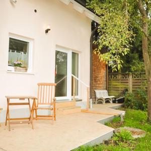 a house with two chairs and a table on a patio at Kleine Bella in Ilmmünster