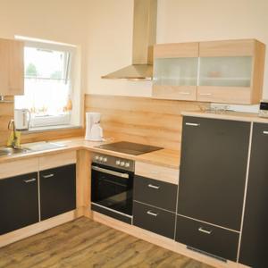 a kitchen with a black oven and a sink at Kleine Bella in Ilmmünster