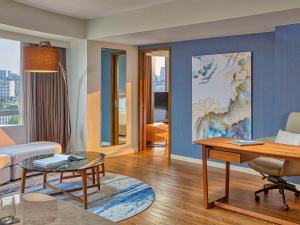 a living room with a couch and a table at Novotel Suites at Acqua in Manila