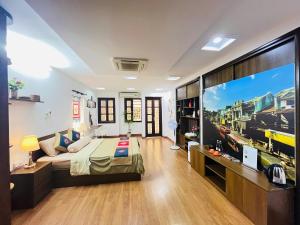 a bedroom with a bed and a large window at Kim's Home in Ba Dinh in Hanoi