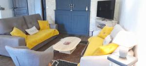a living room with two couches and a yellow couch at ferme des champs in Vrécourt